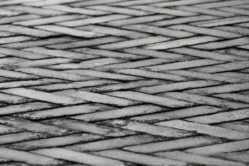 Herringbone brick pattern of the kind stamped concrete copies